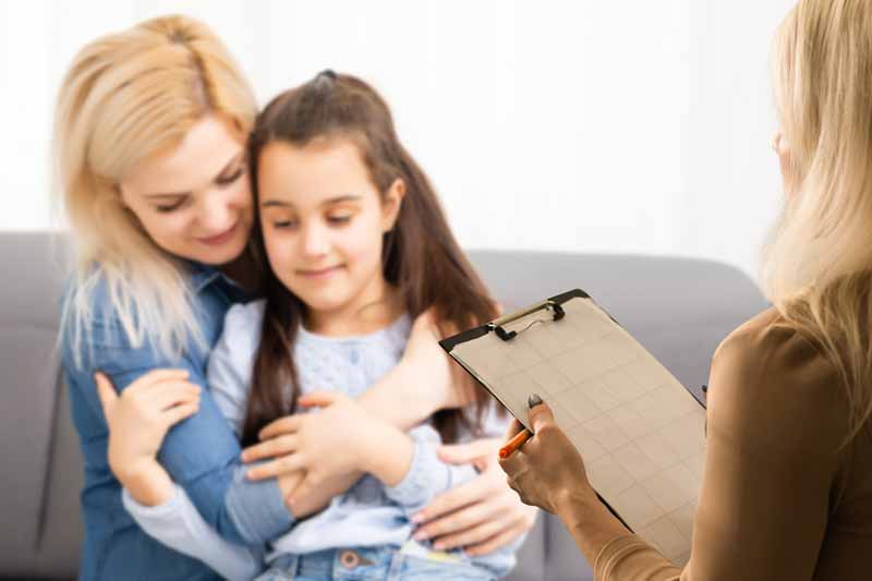 pathologist evaluating child with parent